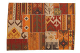 Geometric primitive patchwork Kilim rug with warm colors and visible cross-hatch stitching.