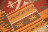 Patchwork Kilim rug showcasing simulated cross-hatch stitches and geometric patterns in warm hues.