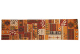 Patchwork Kilim runner with geometric designs, cross-hatch seams, and warm earthy colors.