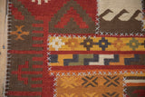 Detail of raised ivory cross-hatch stitching joining panels on a geometric patchwork Kilim runner.