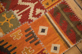 Detail of raised cross-hatch stitching joining geometric panels on a warm-toned patchwork kilim.