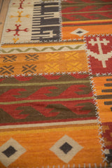 Raised cross-hatch stitches joining geometric panels of a hand-woven patchwork kilim.