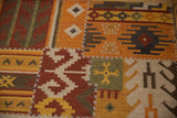 Saffron yellow and olive green panel with primitive motif and cross stitches.