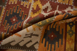 Close-up of geometric patchwork kilim, warm tones and white cross-stitch simulated seams.