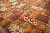 Patchwork Kilim rug section: geometric patterns, cross-hatch stitches, brick red, ivory, and olive.