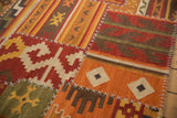Patchwork kilim with geometric finned guls, rams horn motifs, and distinct white cross-hatch stitching.