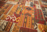 Warm-toned geometric patchwork Kilim detail, red, orange, brown panels, white cross-stitch seams.