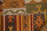 New Patchwork Kilim rug showing warm geometric guls, abstract blossoms, and prominent cross-hatch stitches.