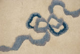 Thick plush ivory wool pile with curvilinear indigo and powder blue cloudband design.