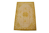 Corner of a vintage Indian Peking carpet with plush ivory field, gold cloudbands, and germinating plant border.
