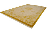 Vintage Indian Peking rug corner, showing saffron yellow germinating plant motifs and fringe.