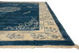 Plush cobalt blue wool field with ivory border, cloudband, and germinating plant motifs.