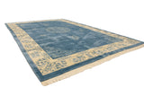 Plush pile and corner of vintage Peking carpet with blue germinating plants on ivory border.