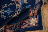 Vintage Peking rug corner with terra cotta border, cobalt geometric pattern, and ivory floral.