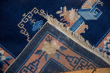 Intact original side selvage and fringe on a vintage Peking rug corner with floral motifs.