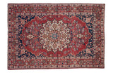 Vintage Persian Baktiari rug with a serrated medallion on a cherry red field and navy blue spandrels.