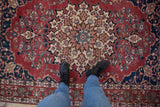 A view from above showing the bold medallion and low-pile texture of a vintage Baktiari rug.