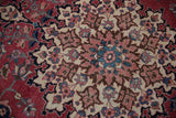 Detailed scrolling arabesques and trefoil blossoms in cherry red, navy, and blush.