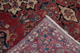 Folded corner showing the hand-knotted construction on the back of a vintage Baktiari rug.