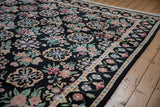 Corner close-up of the vintage Indian carpet showing its dense black pile and original intact selvage.