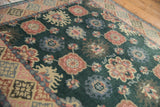 Blush, powder blue floral motifs and geometric border on a vintage Indian rug.