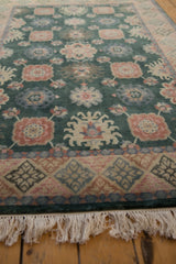Dusty forest green vintage Indian Arts and Crafts rug with blossomed floral motifs and geometric border.