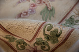 Embossed thick pile and green scrolling leaves on a vintage Chinese Peking rug border.