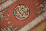 Textured plush pile showcasing the pictorial dragon roundel and ivory border with celadon accents.