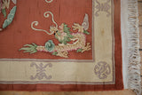 Vintage Peking rug's ivory fringe, corner, intact selvage, and mauve knot motif.