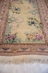 Embossed landscape scene with lovebirds, bamboo, and flowers on vintage Chinese rug.