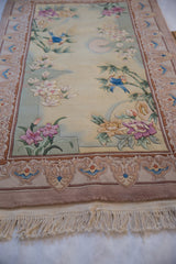 Contemporary Chinese pictorial rug: embossed flowers, lovebirds, ornate border, and fringe.