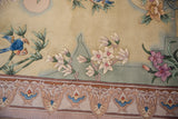 Embossed floral and scroll border detail of a vintage Chinese rug in ivory, mauve, and seafoam.