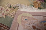 Embossed ivory, seafoam floral pile, woven selvage, fringe of a contemporary Chinese rug.