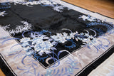 High sheen charcoal pile, denim blue floral blossoms, and platinum border on Art Deco rug corner.