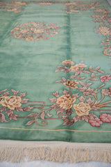 Mint green Art Deco carpet with embossed rose, lotus, and vinery details, plus ivory fringe.