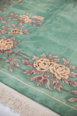 Embossed lotus flowers and geometric vinery on a vintage mint green Chinese Art Deco carpet.