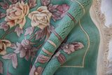 Embossed mint green Art Deco carpet with thick dimensional pile and rose floral motifs.