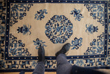 Lustrous ivory field, blue floral medallion details, and the main border of the Peking rug.
