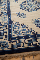 Hand-knotted Vintage Peking rug corner with cobalt blue border, pearl motif, and florals.