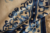 High pile, cobalt blue floral vinery, ivory field, and fringed main border of Peking rug.