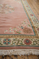Rose Japanese Peking rug corner, displaying coffee brown spandrel, floral border, and ivory fringe.