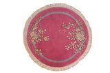 Vintage hand-knotted round Art Deco rug, bubble gum pink, floral sprays, grey band.