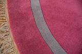 Rich bubble gum pink pile, gray stripe, and original ivory fringe of the Art Deco rug.