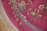 Art Deco carpet's rounded edge, bubble gum pink ground, raised florals, ivory fringe.