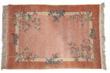 Dusty rose Art Deco rug with embossed floral sprays in blush, blue, and mint.