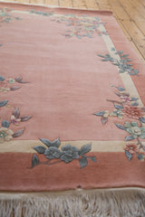 Vintage Art Deco rug corner showcasing embossed floral sprays in dusty rose, blue, and ivory.