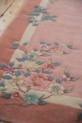 Embossed floral Art Deco pattern on a vintage dusty rose thick pile rug.
