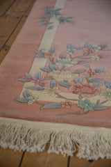 Embossed floral design motif and ivory fringe of a vintage Art Deco rug.
