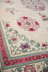 Vintage Japanese Peking rug featuring pink, seafoam, and blue floral cloudband motifs.