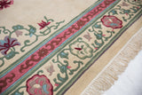 Vintage Japanese Peking rug border detail with vibrant floral motifs, green vines, pink cloudband, full pile.